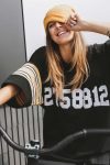 girl-in-hockey-jersey-style-with-street-bicycle-PEKUWLK-scaled.jpg